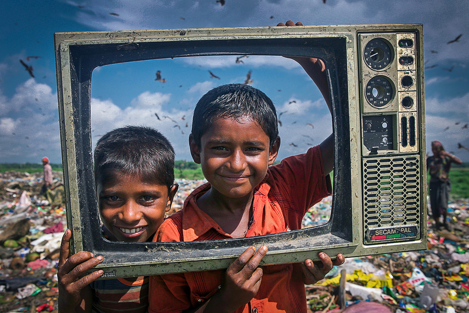 The Children at fun to front of Camera with waste TV frame.
The poor Children pick sellable household materials and sell to market for their livelihood. The permanent Waste land under Sylhet City Corporation. Lalmatia, Sylhet, Bangladesh.