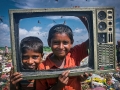 The Children at fun to front of Camera with waste TV frame.
The poor Children pick sellable household materials and sell to market for their livelihood. The permanent Waste land under Sylhet City Corporation. Lalmatia, Sylhet, Bangladesh.