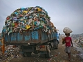 A man is go to market for selling collected materials and another waste carrying trucks are entering. The permanent Waste land under Sylhet City Corporation. Lalmatia, Sylhet, Bangladesh